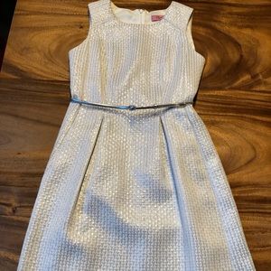 White dress with silver metallic stitching.
